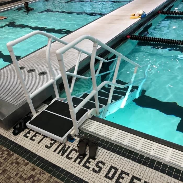 ADA-compliant pool lift staged at the edge of a lap pool