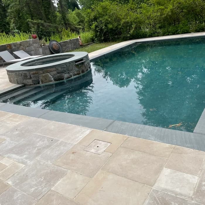 Backyard pool with fire pit and spa built by Marine Pool Renovations