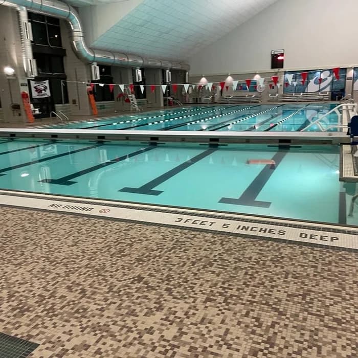 Indoor lap pool with mosaic tile deck and pennant banners