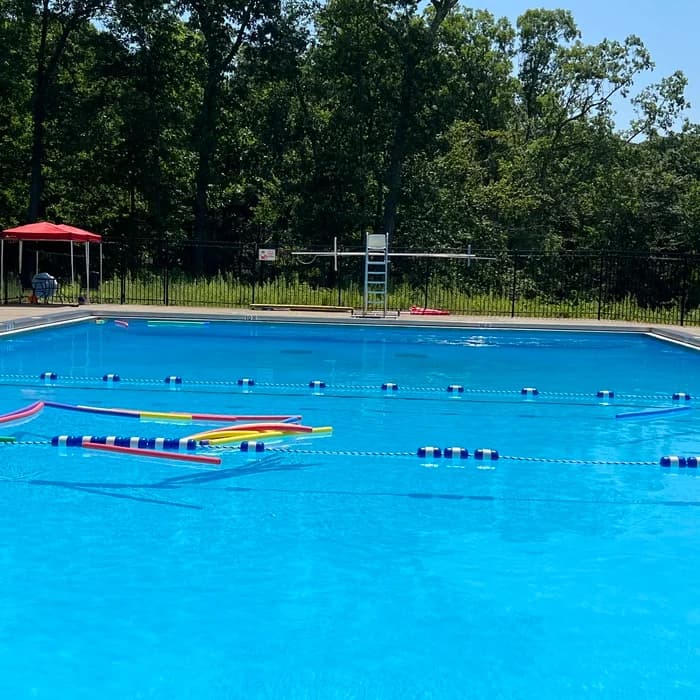 Outdoor club lap pool with lane lines and diving board