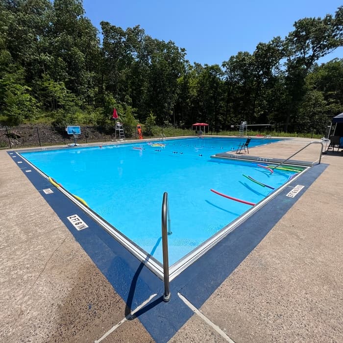 Outdoor club lap pool corner view with safety equipment