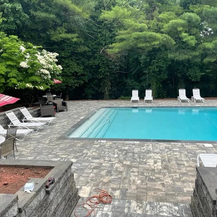 Finished paver patio and pool decking during the finishing stage